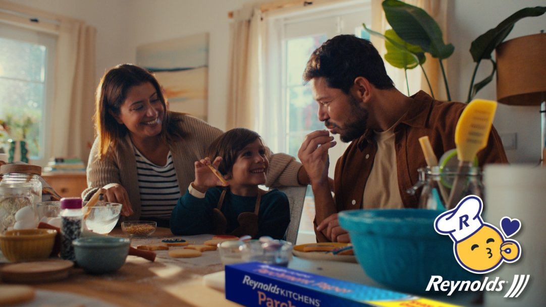 Family sitting around a kitchen island making cookies together