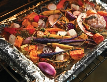 Roasted vegetables on a foil lined baking sheet