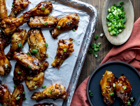 Hoisin chicken wings on a baking sheet lined with Reynolds Wrap Aluminum Foil