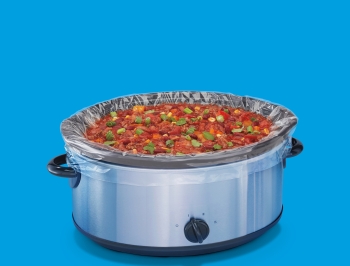 Food cooking in a slow cooker that is lined with a slow cooker liner
